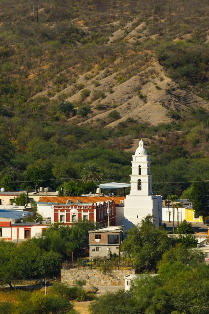 Charming village of Bacanora with its iconic church against rugged hills in Sonora, Mexico.